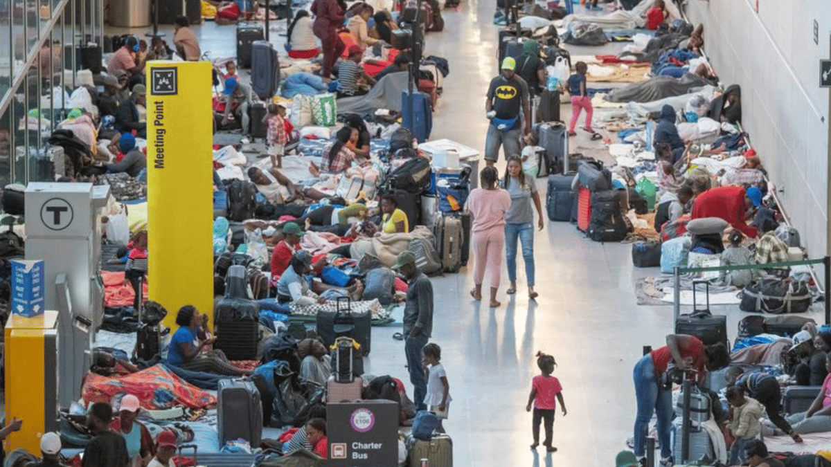 عشرات المهاجرين يفترشون الأرض في مطار بوسطن (فيديو)