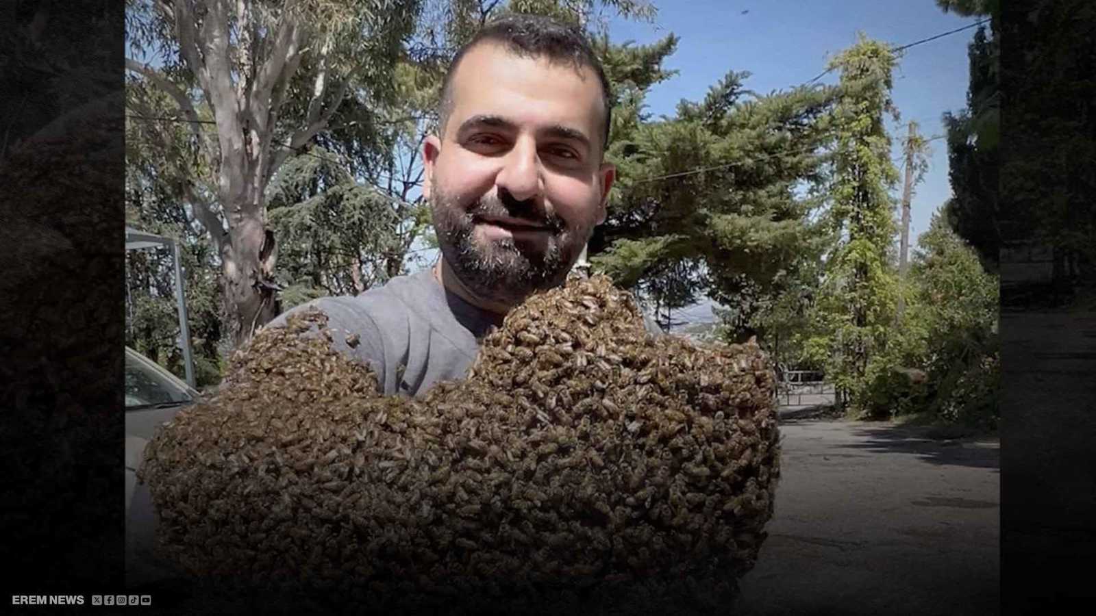 بجرأة مذهلة ودون قفازات.. لبناني يحمل بيده 12 كيلوغراماً من النحل (فيديو إرم)