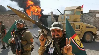 عناصر مسلحة تابعة للحشد الشعبي بالعراق