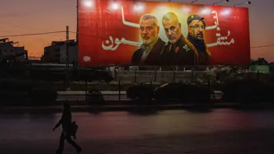 ملصق في بيروت لإسماعيل هنية وقاسم سليماني وفؤاد شكر