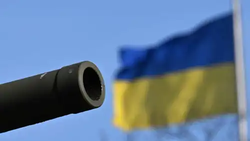فوهة مدفع أمام العلم الأوكراني 