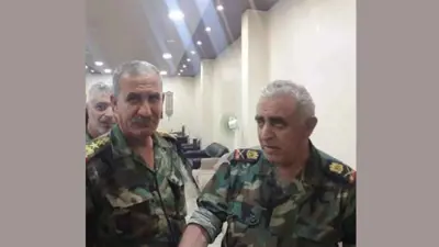 اللواء جميل الحسن على يمين الصورة