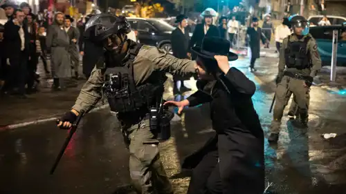 شرطي إسرائيلي يقتاد متظاهرا من الحريديم