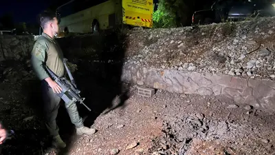 جندي إسرائيلي يقف في موقع سقوط صاروخ لبناني