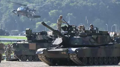 جنود أمريكيون  يقفون على دبابة أمريكية من طراز M1A2