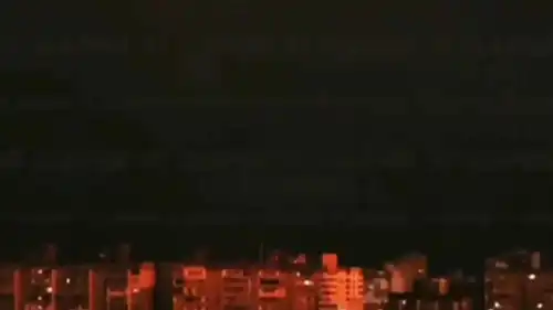 أضواء الانفجارات تنعكس على المباني في كييف