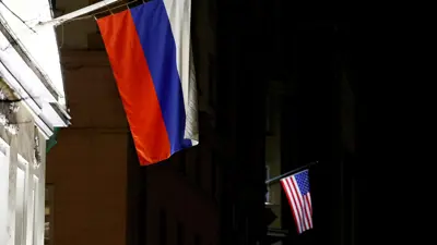 العلم الروسي على واجهة مبنى تاريخي إلى جانب العلم الأمريكي على واجهة السفارة الأمريكية في موسكو، روسيا