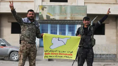 كرديان يرفعان علم "قسد"