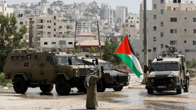 علم فلسطين بجوار مركبات إسرائيلية في طولكرم