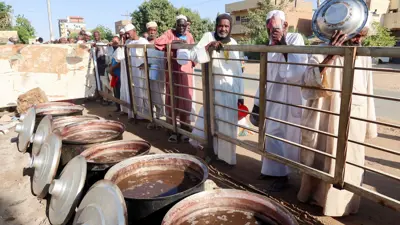 سودانيون ينتظرون دورهم للحصول على وجبة 