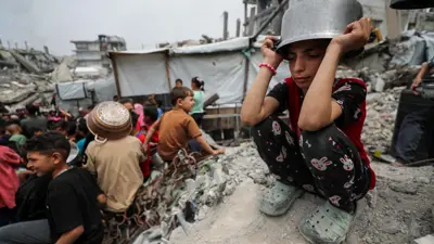 فتاة من غزة تضع على رأسها قدرا فارغا