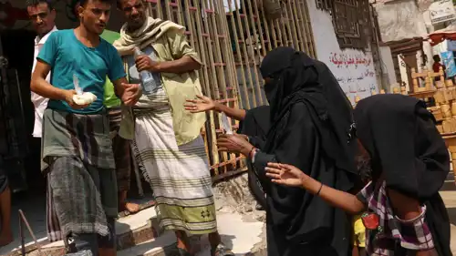 عائلة يمنية تحاول الحصول على الغذاء