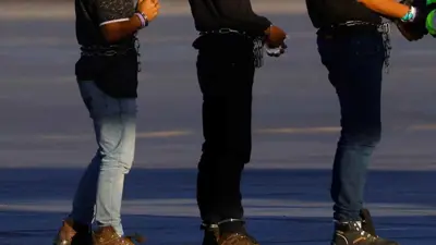 مهاجرون في أمريكا مكبلون بالأصفاد  