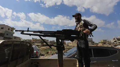 مسلح تابع للأمن السوري في درعا