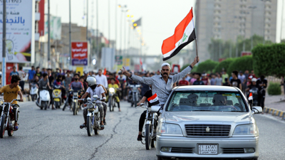 شخص يحمل العلم لعراقي