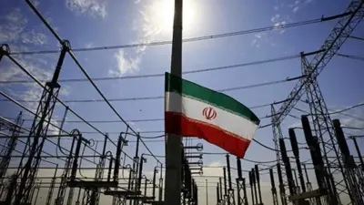 علم إيران وسط أبراج كهرباء  