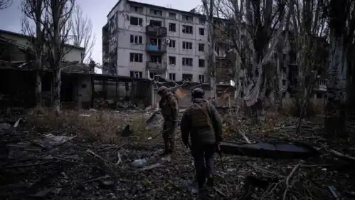 جنود أوكرانيون بجوار أحد المباني المدمرة في بلدة كوستيانتينيفكا 