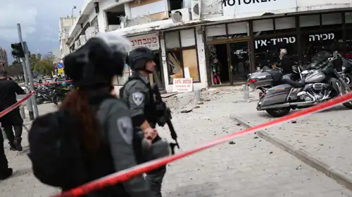 جنود إسرائيليون يتفحصون موقعا سقطت فيه صواريخ إيرانية